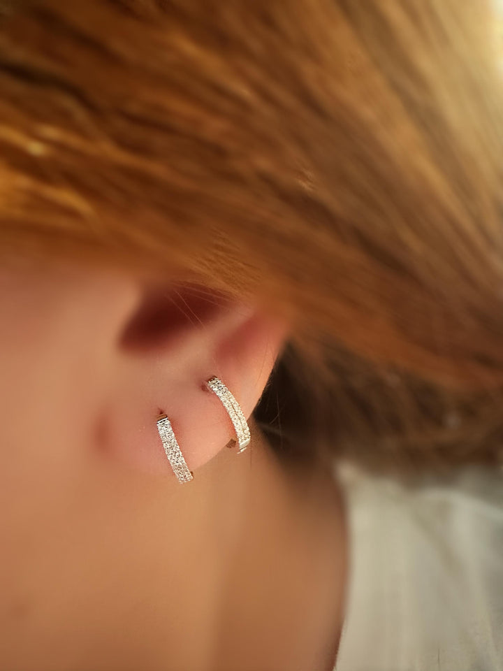 Trendy 18k solid gold diamond huggie earrings with double rows of natural diamonds. Lightweight, minimalist, and perfect for everyday wear or stacking. Gen Z-approved fine jewelry—real gold, real diamonds, no plating. Great for self-gifting or casual luxe style.